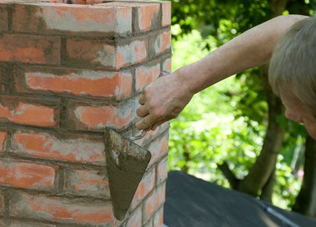 Trowel filling freshly raked joints on a stack face